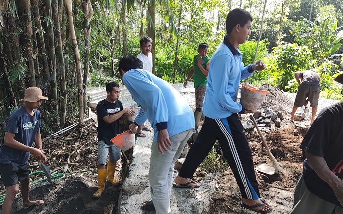 Mahasiswa KKN Posko 54 bergotong royong dengan warga membangun jalan